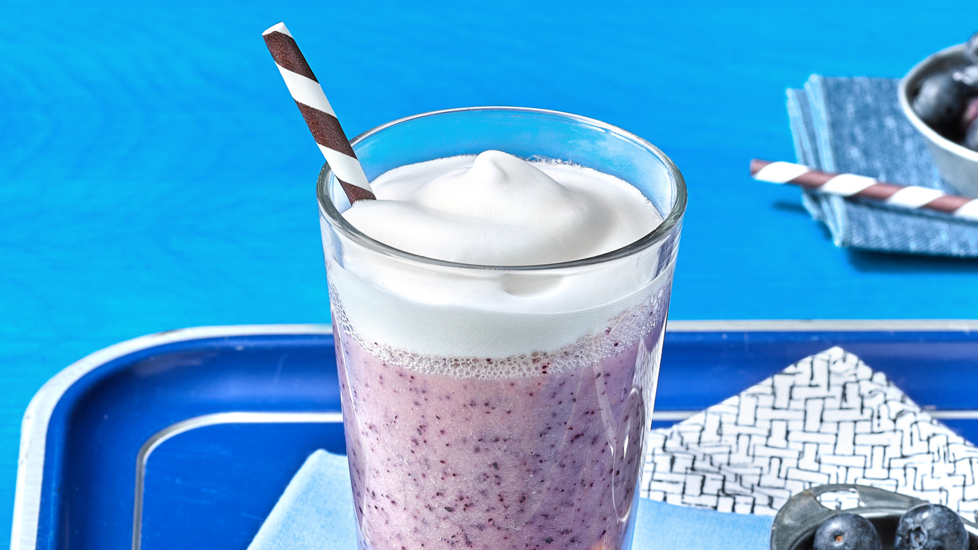 Purple Bean Smoothie featured on a blue tray with a blue background.