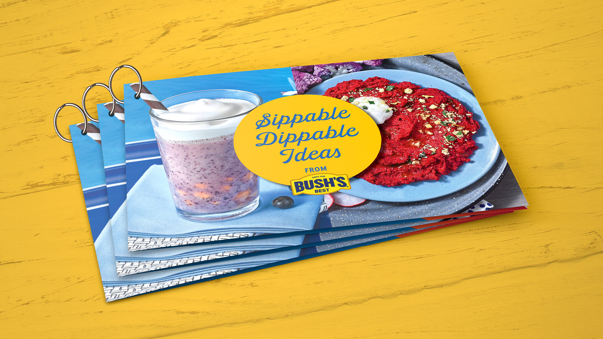 Bush's Sips and Dips recipe guide. Three printed ringed booklets that say "Sippable Dippable Ideas."